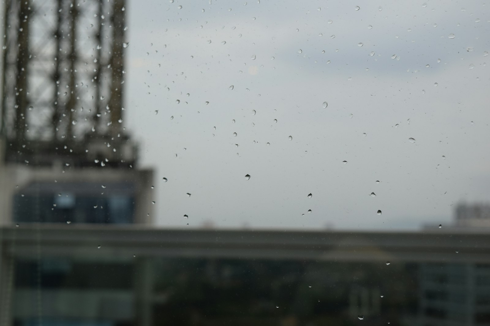 a view of a building through a rain covered window