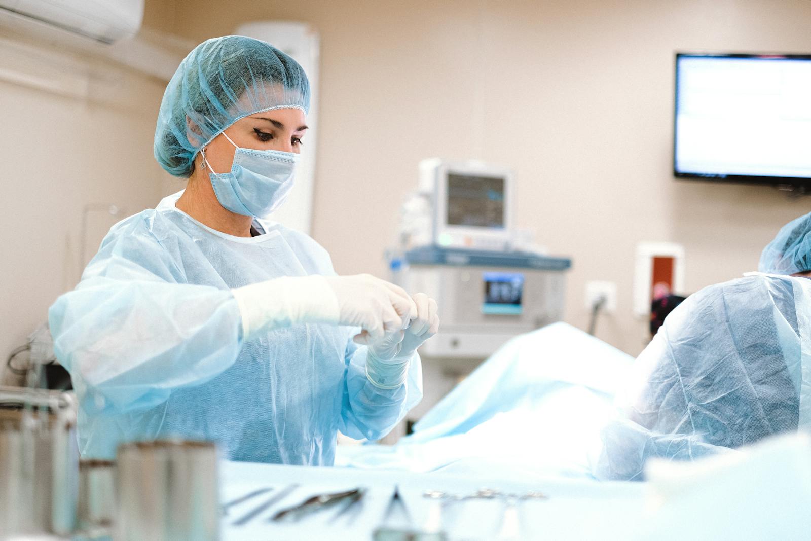 Female surgeon in sterile operating room preparing for a surgical procedure, emphasizing healthcare professionalism.