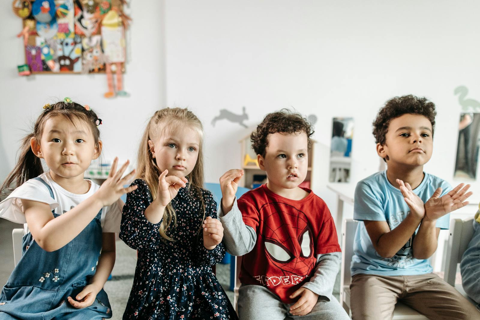 A group of diverse children engaged in a fun activity in a preschool classroom setting.