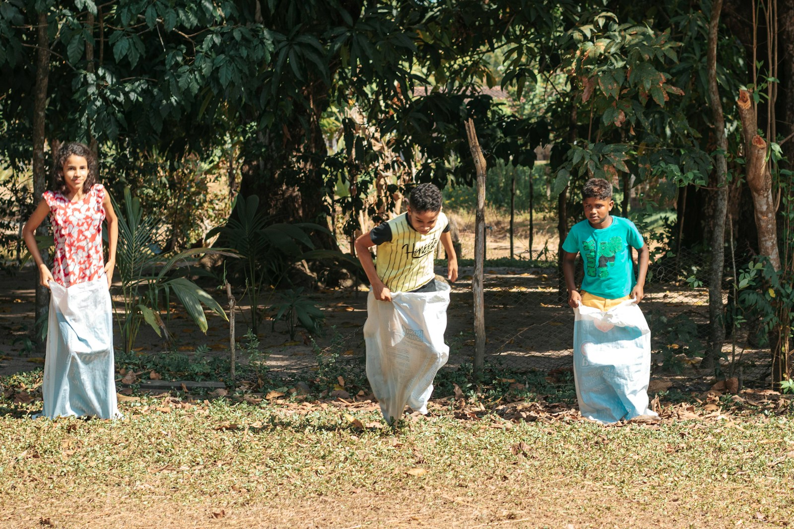 man in blue polo shirt and white pants standing beside woman in white dress during daytime