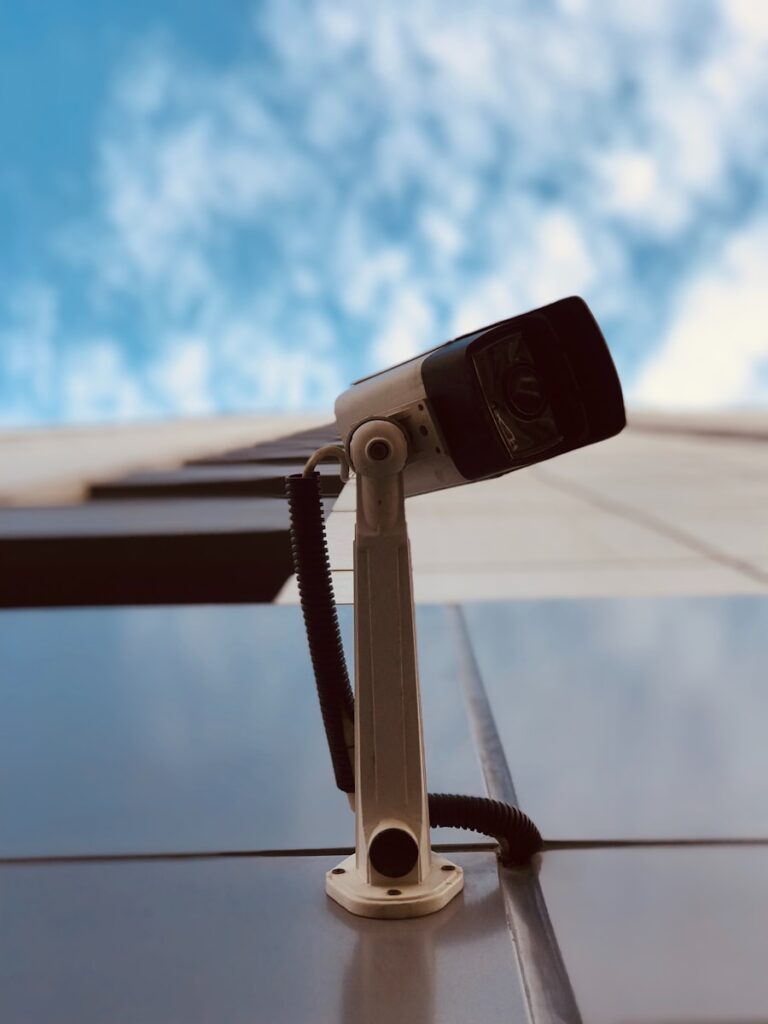 A video camera sitting on top of a table next to a pool