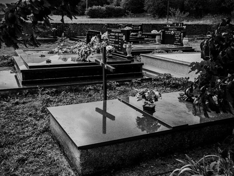 grayscale photo of a cross on a table